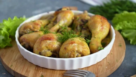 Fried chicken drumstick served in white bawl with green salad and turmeric Stock Footage 168927956