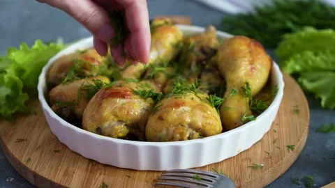 Fried chicken drumstick served in white bawl with green salad and turmeric Stock Footage 168928597