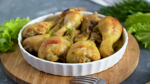 Fried chicken drumstick served in white bawl with green salad and turmeric Stock Footage 168928605
