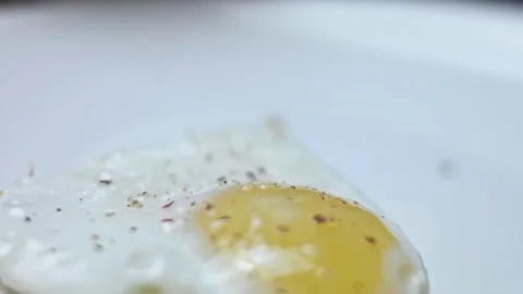 Fried chicken egg, shape in the form of a heart. Fried egg seasoned with salt Stock Footage 146666884