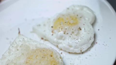 Fried chicken eggs, shape in the form of a heart. Adding parmigiano reggiano Stock Footage 146667895