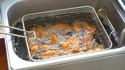 Fried chicken in fried pot with boiling cooking oil Stock Footage 134745755