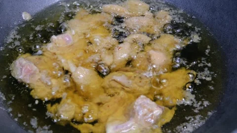 Fried chicken in a frying pan with boiling hot oil Stock Footage 309583056