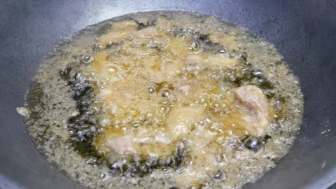 Fried chicken in a frying pan with boiling hot oil Stock Footage 309583058
