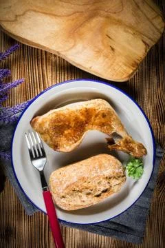 Fried chicken leg with bread roll. Stock Photos