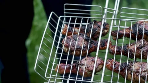 Fried chicken legs in grid for grilling. Stock Footage 209185658