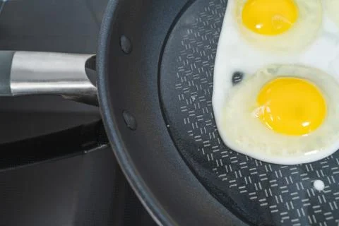 Fried chicken non-stick pan on a black background Stock Photos