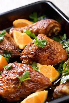 Fried chicken with oranges Stock Photos