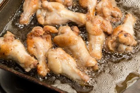 Fried chicken in the pan Stock Photos