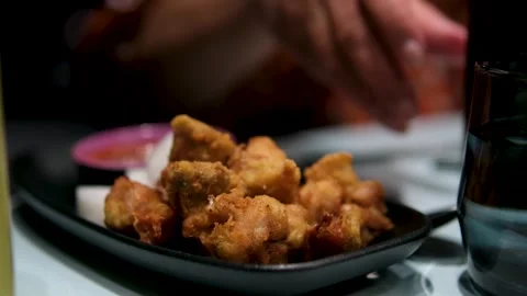 Fried chicken plate Plate of crispy fried chicken with vegetable salad and a Stock Footage 307742411