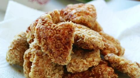 Fried chicken is rotated. Backlight. Man's hand takes a slice Stock Footage 68895308