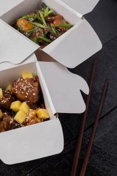 Fried chicken set in a box, wok noodles and chopstocks. Top view Stock Photos