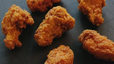 Fried chicken strips with on a black background. Rotating video Stock Footage 250113597