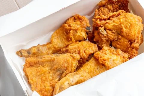 Fried chicken in a take out box container Stock Photos