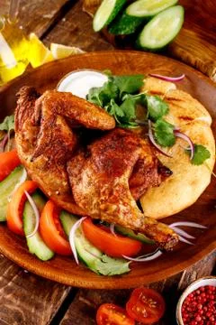 Fried chicken with vegetables and bread on a plate Stock Photos