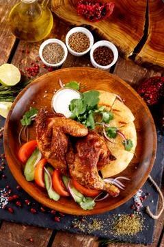 Fried chicken with vegetables and bread on a plate Stock Photos