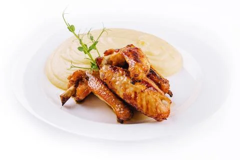 Fried chicken wings and mashed potatoes on plate Stock Photos