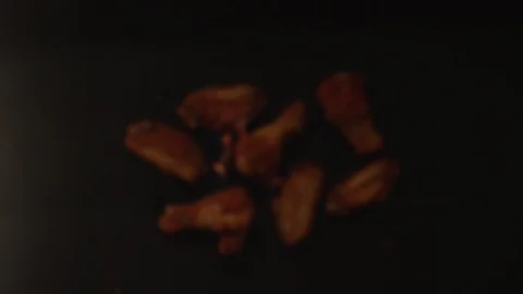 Fried chicken wings fly upwards with blazing fire. Slow motion video Video stock 116601810