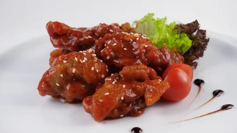 Fried chicken wings in sauce, topped with sesame seeds Stock Footage 80143032