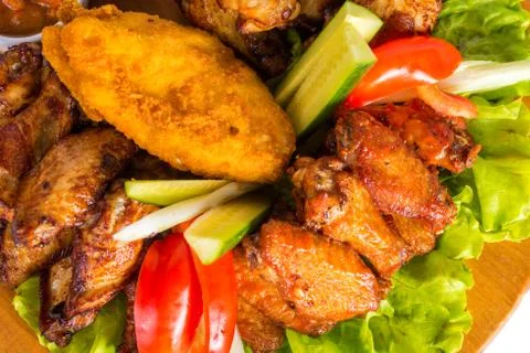 Fried chicken wings with vegetables Stock Photos