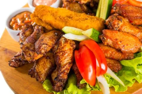 Fried chicken wings with vegetables Stock Photos