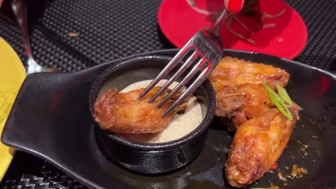 Fried chicken wings with white sauce Pouring fry chicken in white creamy sauce Stock Footage 293170970