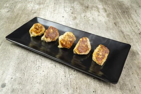 Fried chinese dim sum dumpling in the plate on the table Stock Photos