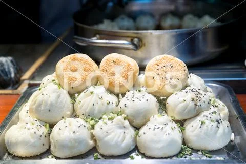 Fried Chinese pork bun in food market, Shanghai, China. Tradition Shanghai Ch Stock Photos
