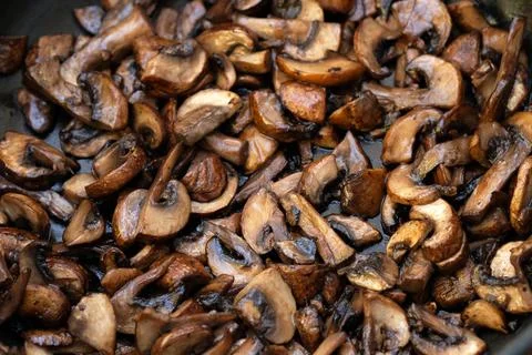 Fried chopped champignons top view. Stock Photos
