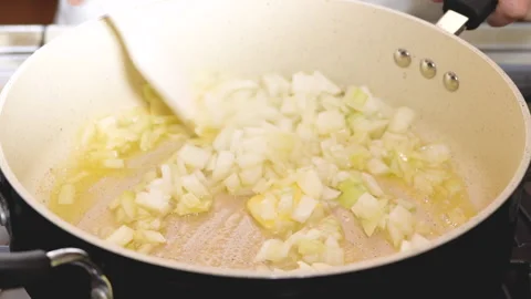 Fried chopped onion on frying pan, close up cooking process Stock Footage 148293353