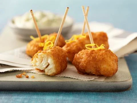 Fried cod cheeks with lemon zest Stock Photos
