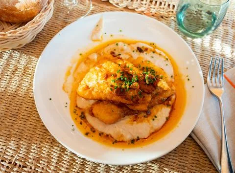 Fried cod with creamy white beans and gravy Stock Photos
