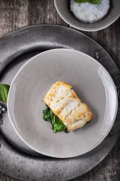 Fried cod fillets and spinach Stock Photos