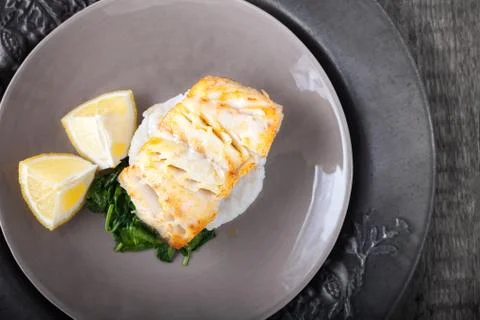 Fried cod fillets and spinach Stock Photos