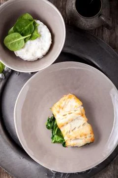 Fried cod fillets and spinach Stock Photos