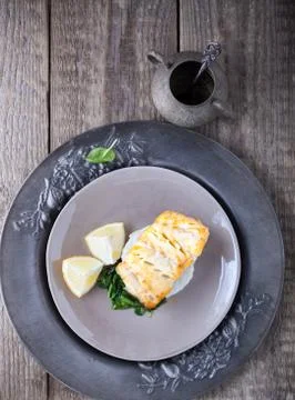 Fried cod fillets and spinach Stock Photos