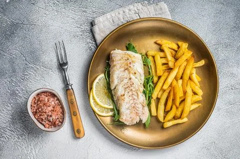 Fried cod fish fillet served with french fries. White background. Top view 스톡 사진