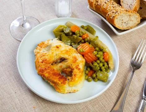 Fried cod fish garnished with vegetable ragout Stock Photos