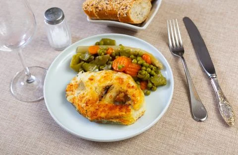 Fried cod fish garnished with vegetable ragout Stock Photos