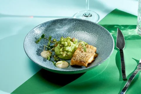 Fried cod with mashed peas and truffle oil. Bright backgrounds. Hard shadows, Stock Photos