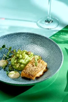 Fried cod with mashed peas and truffle oil. Bright backgrounds. Hard shadows, Stock Photos