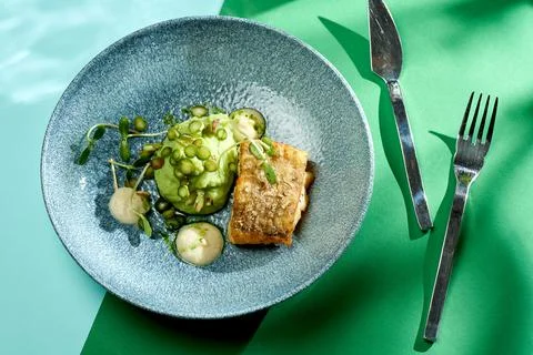 Fried cod with mashed peas and truffle oil. Bright backgrounds. Hard shadows, Stock Photos