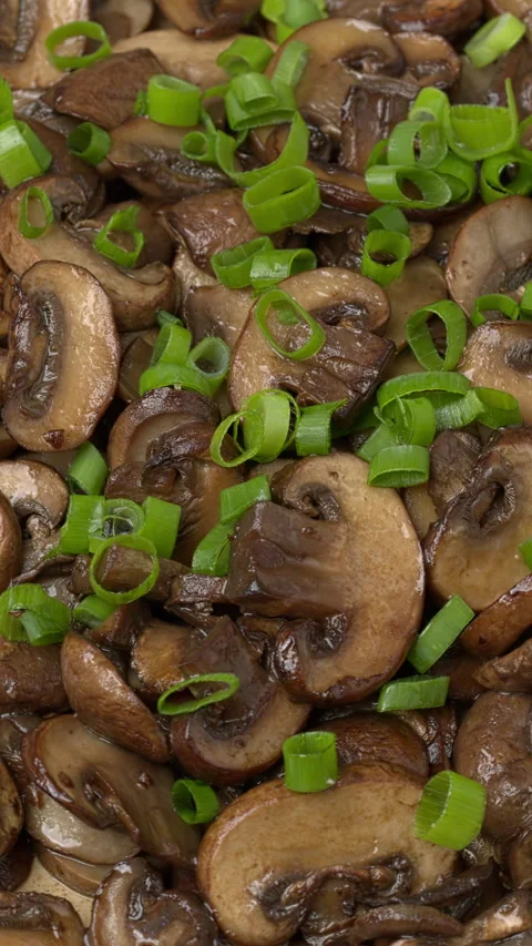 Fried cremini mushrooms background. Vertical video. Stock Footage 311950922