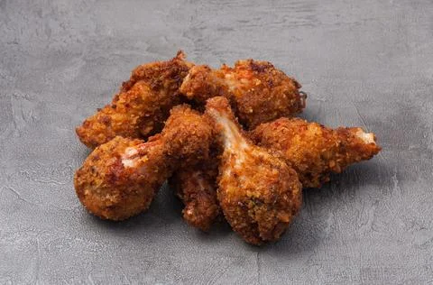 Fried crispy breaded chicken wings on a gray background Stock Photos