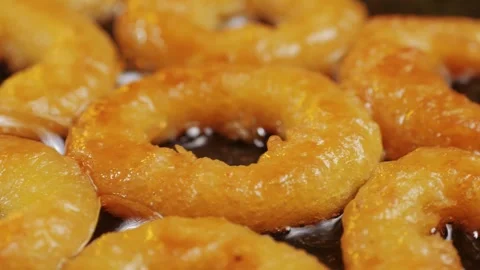 Fried crispy onion rings in a frying pan with oil close-up macro. Roasted onion Stock Footage 265909808
