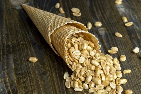 Fried crispy peanuts in a waffle cone for ice cream Foto stock