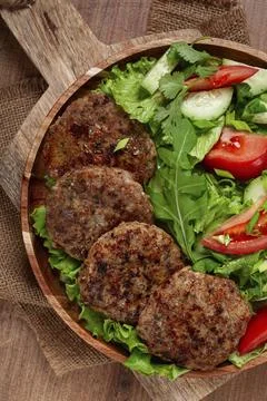Fried cutlets, mixed minced meat, with vegetable salad, homemade, top view, no Stock Photos