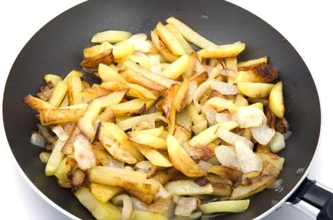 Fried cutting potatoes in griddle Stock Photos
