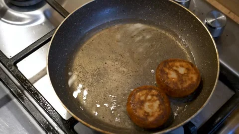Fried Donuts Being Picked From Boiling Pan with fork and spoon, high-angle view. Vidéo 264916384