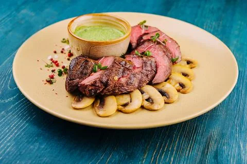 Fried dry aged angus beef filet medaillons natural with mushrooms Stock Photos